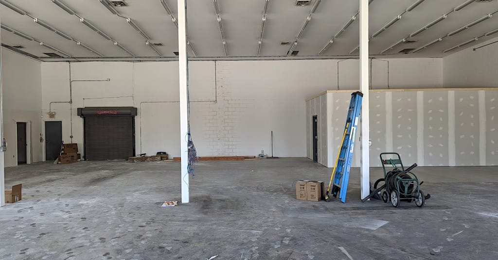 interior of building showing framed out rooms covered with drywall