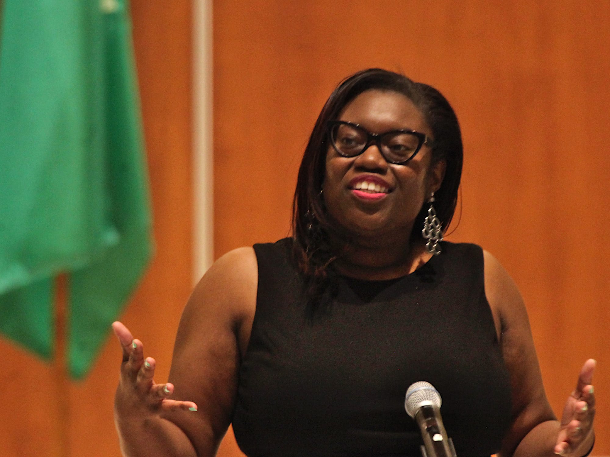 woman standing at microphone and podium