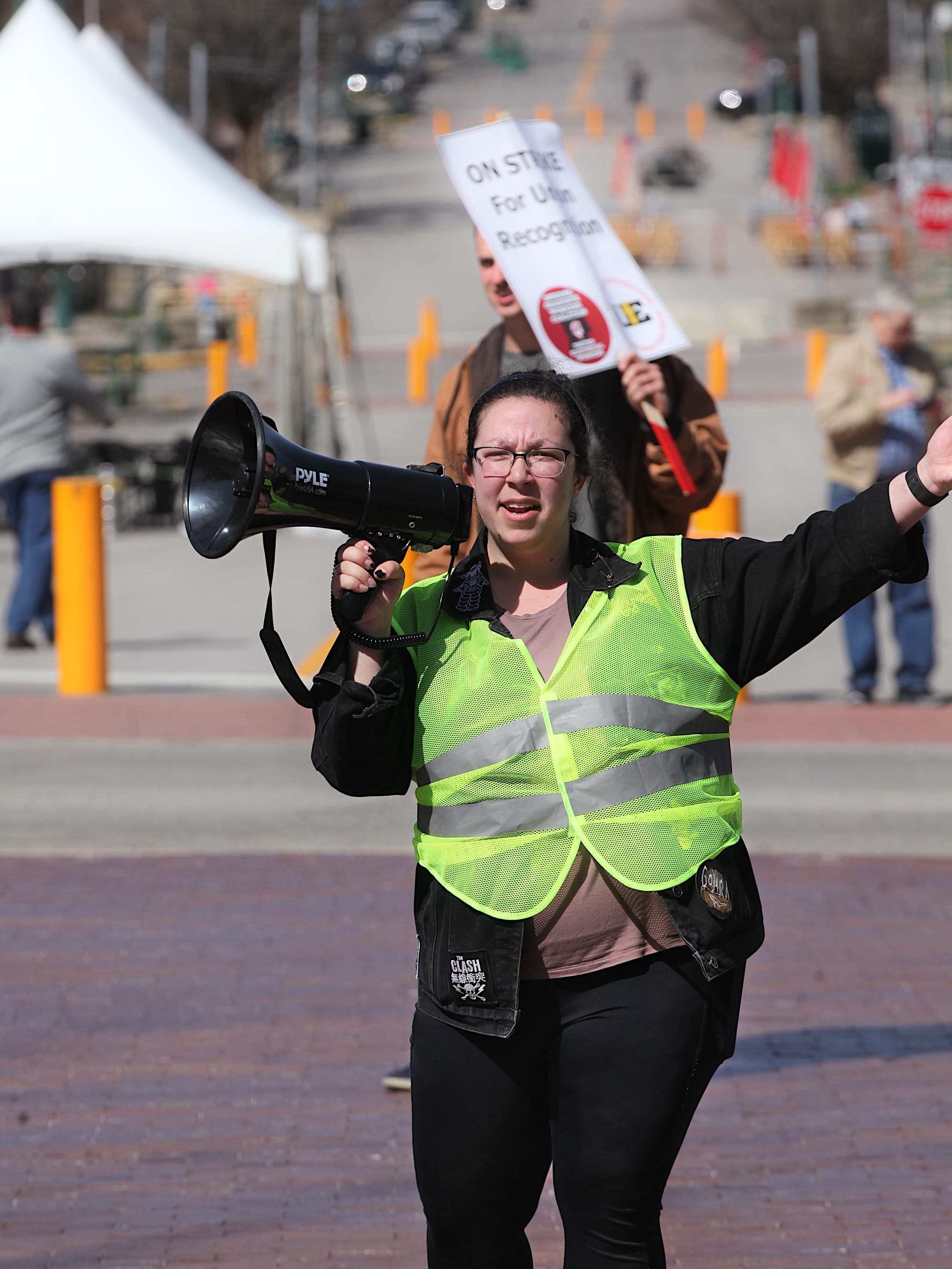 The signs say "On strike for union recognition."