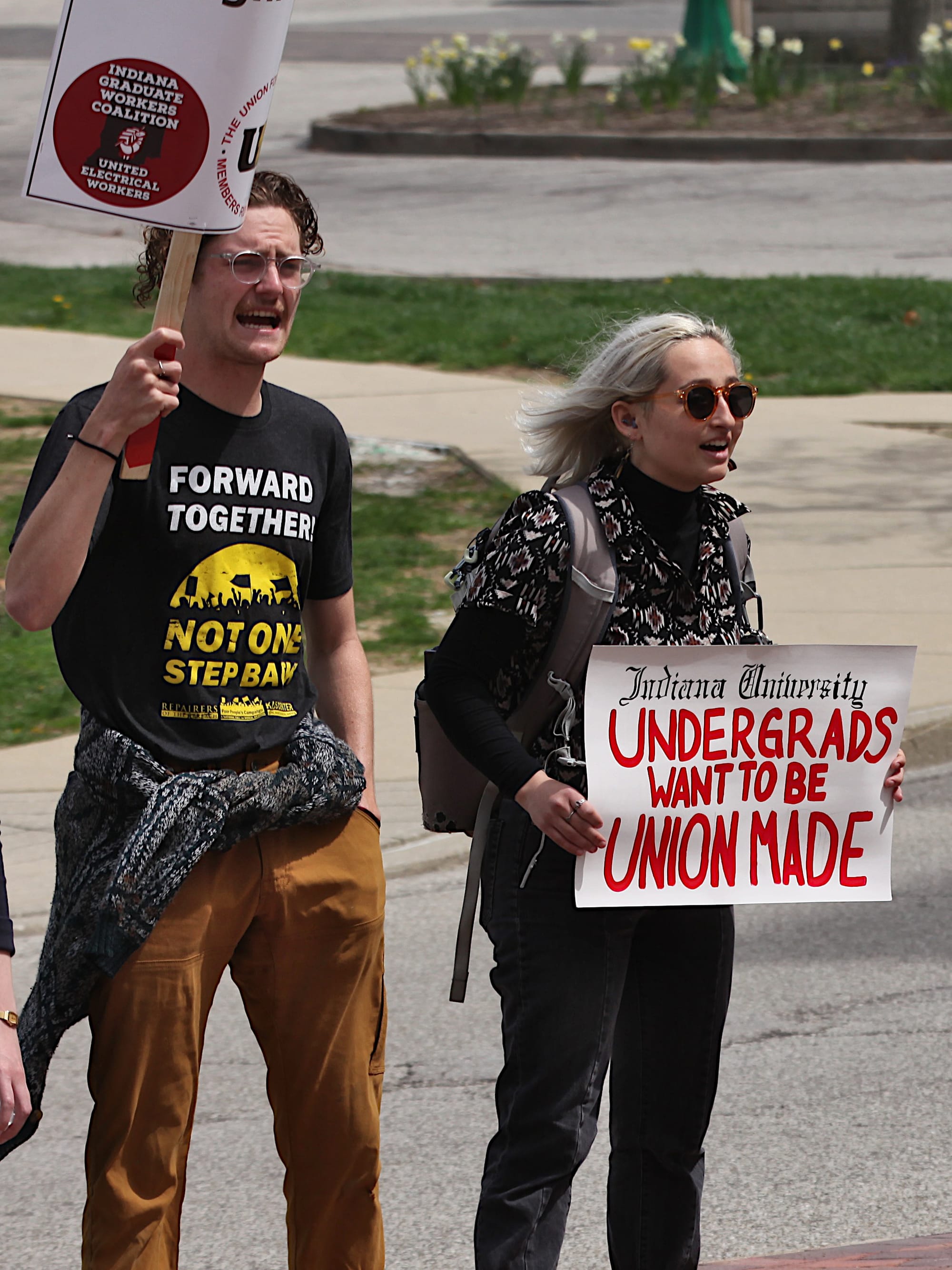 Woman holding a sign. The sign says "Indiana University undergrads want to be union made."