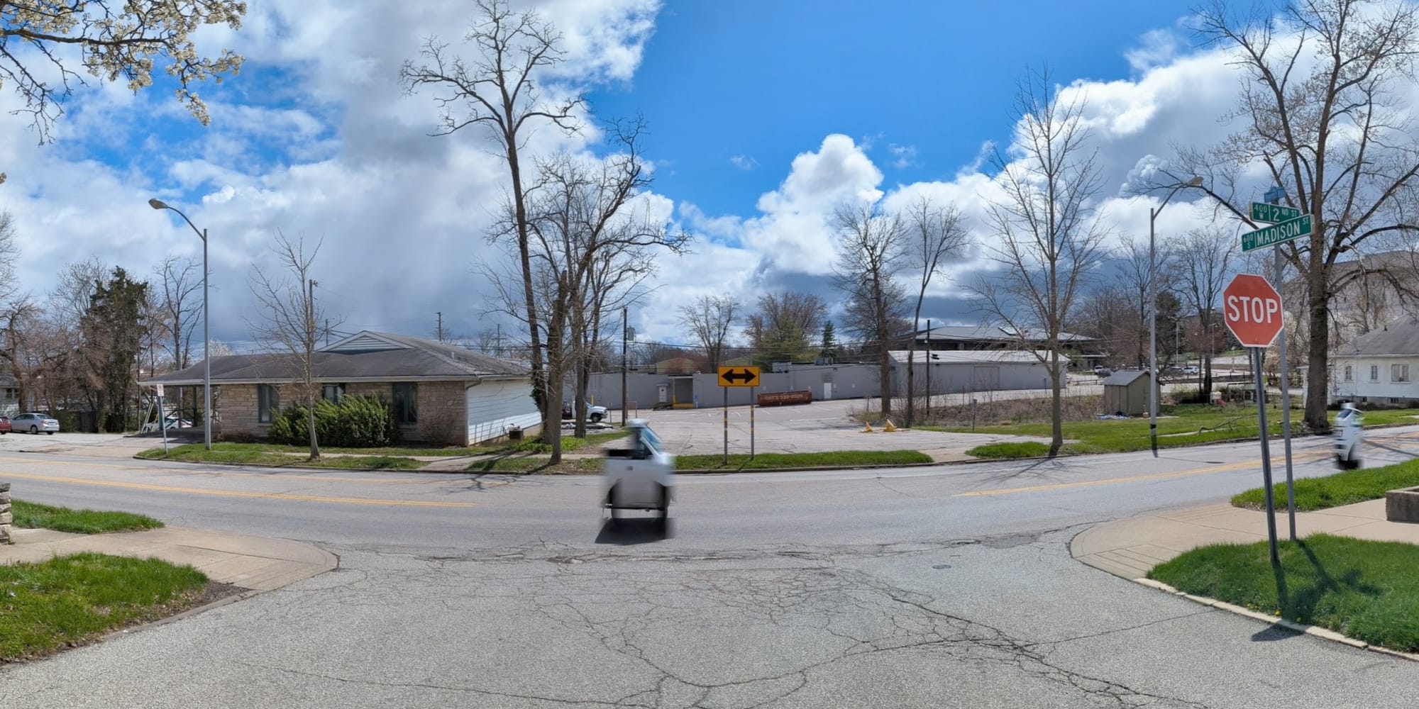 view from the middle of a street that Ts into another street to show the area where the street will be extended.