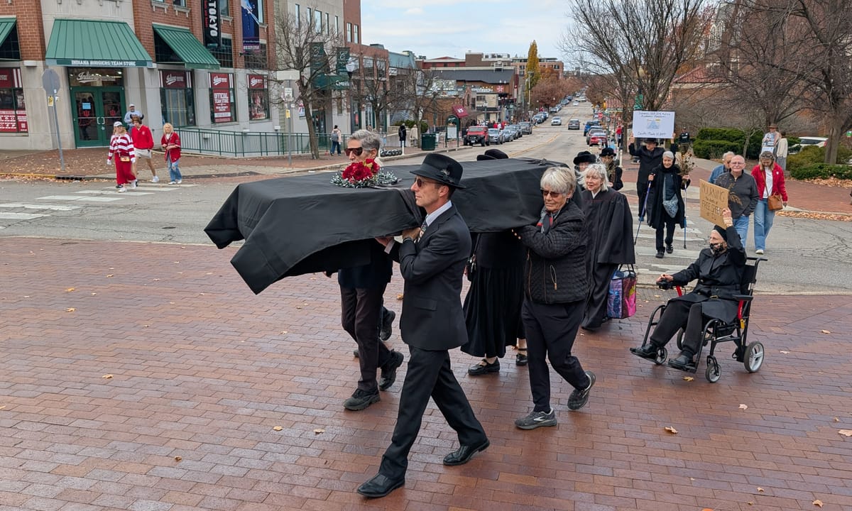Before kickoff on gameday, protesters hold ‘funeral’ for free speech at Indiana University