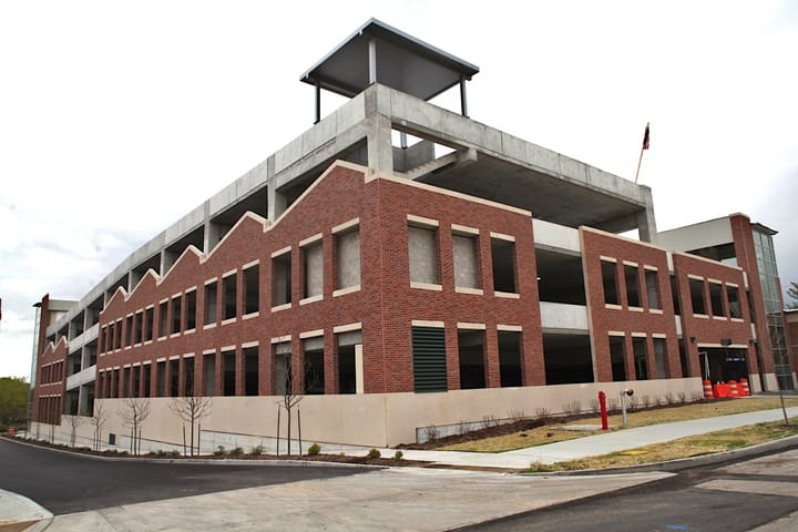 Parking garage ribbon cutting marks transition, a prelude to hoped-for development
